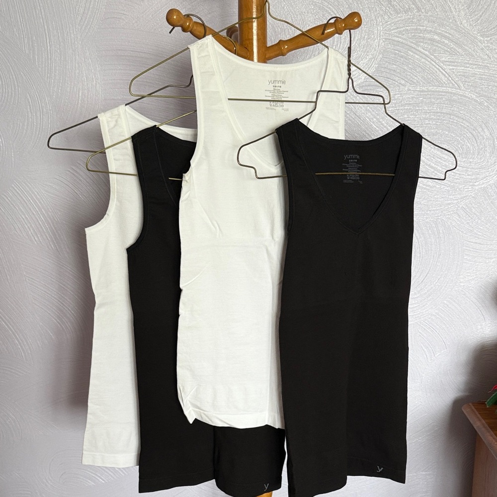 Four Yummie tank tops, two black and two white